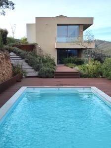 a house with a swimming pool in front of a house at La sentinelle du Vallespir, Spa Sauna in Vivès
