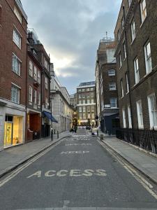an empty street with the words excess written on the road at Holborn Apartments in London