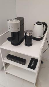 a white shelf with a coffee maker and a appliance at Appartamenti Reali Bonaccini in Milan