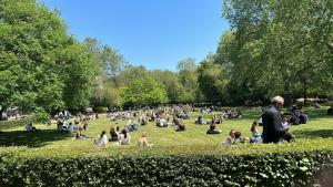 a crowd of people sitting on the grass in a park at Holborn Apartments in London