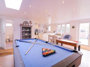 a pool table in a living room with at Hide and Sleep in Walton-on-the-Naze