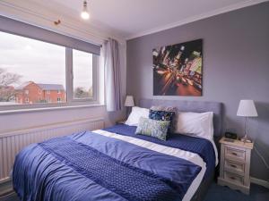 a bedroom with a bed and a large window at Hide and Sleep in Walton-on-the-Naze