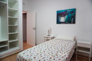 a bedroom with a bed and a painting on the wall at Holiday House Blue Sky La Gomera in San Sebastián de la Gomera
