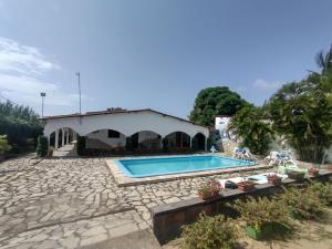 a swimming pool in front of a house at Pousada dos Arcos e Condomínio in Conde