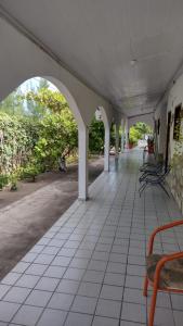 einen leeren Flur eines Gebäudes mit Stühlen und Tischen in der Unterkunft Pousada dos Arcos e Condomínio in Conde