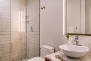 a bathroom with a toilet and a sink and a shower at Sonder Duane Street in New York