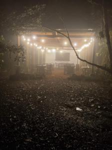 a foggy night with lights on a patio at Refugio La Paz EcoGlamping in San Ramón