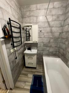 a bathroom with a bath tub and a sink at Apartment Kyiv in Kyiv