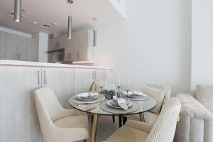 a dining room with a table and chairs in a kitchen at Modern 1 bedroom at Palm Jumeirah in Dubai