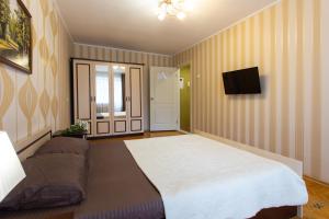 a bedroom with a large bed and a couch at Botanical garden area in Kharkiv