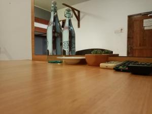 two bottles sitting on top of a wooden table at Andorra Tourist Resort Anuradhapura in Anuradhapura