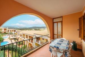 a balcony with a view of a resort at Residenza del Sole 1 in Villasimius