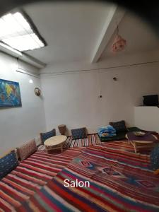 a living room with a large rug on the floor at Dar Sahara Ouarzazate in Ouarzazate