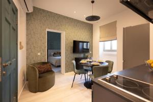 a kitchen and living room with a table and chairs at Marina View 34 in Birgu