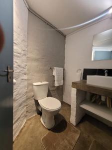 a bathroom with a white toilet and a sink at Trendy apartments _ @ Craftsmanship on main in Johannesburg