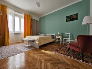 a bedroom with a bed and a table and a chair at Casa Torino Liberty in Turin