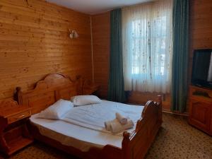 Postel nebo postele na pokoji v ubytování Complex Țurcana Transalpina