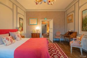 a bedroom with a bed and a desk and a piano at la Forge du Roy in Blois