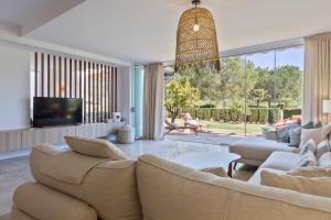a living room with a couch and a tv at Las Terrazas de Santa Clara in Marbella