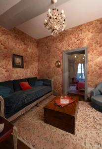 a living room with a couch and a table at la Forge du Roy in Blois