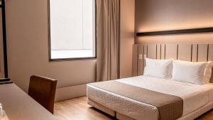 Plaza Hotel & Boulevard Convention - Vale dos Vinhedos客房内的一张或多张床位