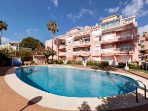 a swimming pool in front of a building at PLAYA Denia BEACH ESTUDIO in Denia