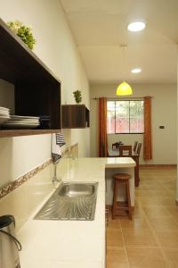 a kitchen with a sink and a counter top at Casa habitacion, 4 dormitorios in Tarapoto
