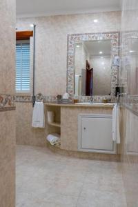 a bathroom with a sink and a mirror at Quinta Vale Lameiros 