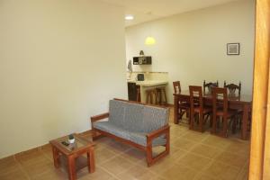 a living room with a table and chairs and a dining room at Casa habitacion, 4 dormitorios in Tarapoto