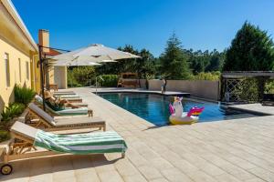 a swimming pool with chaise lounges and a swimming pool at Quinta Vale Lameiros 