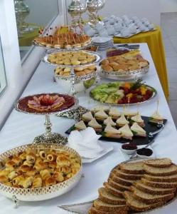 a buffet with many plates of food on a table at Villa Del Sol Hotel Fortaleza in Fortaleza