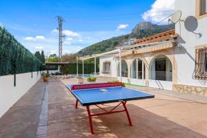 a ping pong table on the patio of a building at Villa Mercedes - Plusholidays in Calpe
