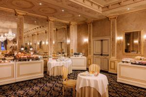 a dining room with two tables and a buffet at Palace Hotel Lake Como in Como