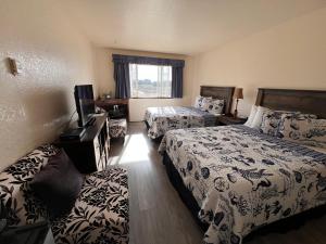 um quarto de hotel com duas camas e um sofá em Gualala Country Inn em Gualala