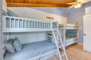 a bunk bed room with two bunk beds and a ladder at Waterfront Shelby Home with Fireplace and Scenic Decks in Shelby