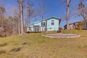 a blue house in the middle of a yard at Waterfront Shelby Home with Fireplace and Scenic Decks in Shelby