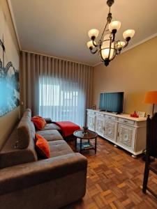 ein Wohnzimmer mit einem Sofa und einem TV in der Unterkunft Art Gallery Apartment in Porto