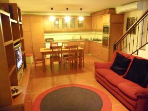 a living room with a red couch and a table at 2 bedrooms house at Vila de Rei in Vila de Rei