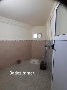 an empty bathroom with a toilet in a room at Dar Sahara Ouarzazate in Ouarzazate