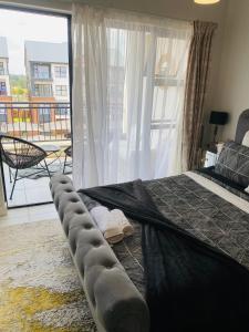 a bedroom with a large bed with a large window at Luxury beach lagoon 1 Bedroom apartment in Pretoria +51 photos