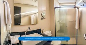 a bathroom with a shower and a sink at Roomo Praia de Boa Viagem Residencial in Recife