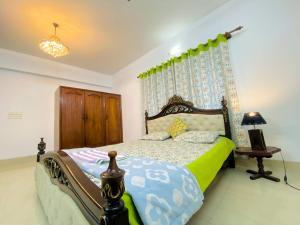 a bedroom with a bed and a lamp and a table at Cozy private Ac Attached bath Room- Gulshan 1 in Dhaka