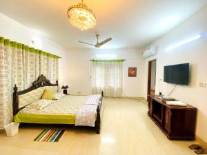 a bedroom with a bed and a flat screen tv at Cozy private Ac Attached bath Room- Gulshan 1 in Dhaka