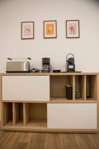 a wooden shelf with a microwave on top of it at Casa Boschi in centro città in Pescara