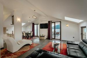 a living room with a couch and a table at Apartments Joy in Herceg-Novi