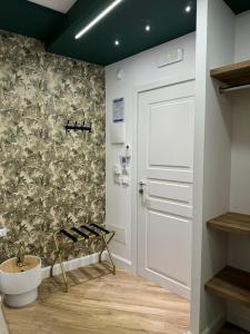 a bathroom with a white door and a wall at Le Suite Piazza Nuova in Foggia