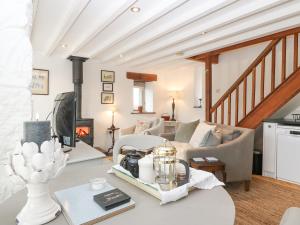 a living room with a couch and a fireplace at The Coach House in Pwllheli