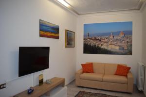 uma sala de estar com um sofá e uma televisão de ecrã plano em l'Île di Ile em Florença