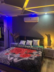 a bedroom with a bed with a painting on it at Sallam Lux Property in Hurghada