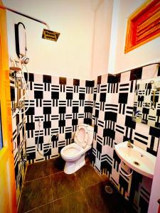 a bathroom with a toilet and a sink at River view family rest in Demodera